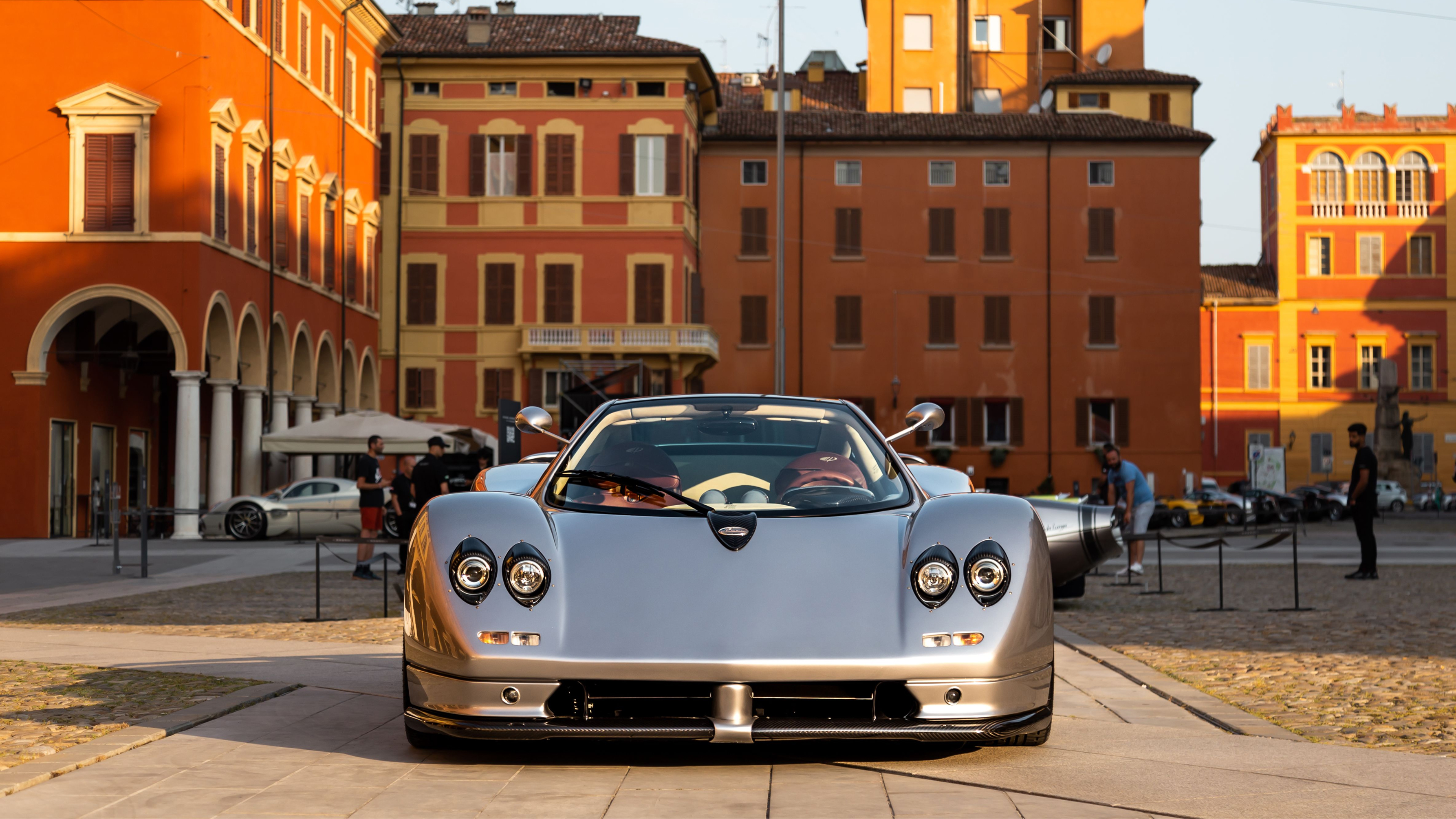Silver Pagani Zonda C12 parked in a Modena piazza at sunset
