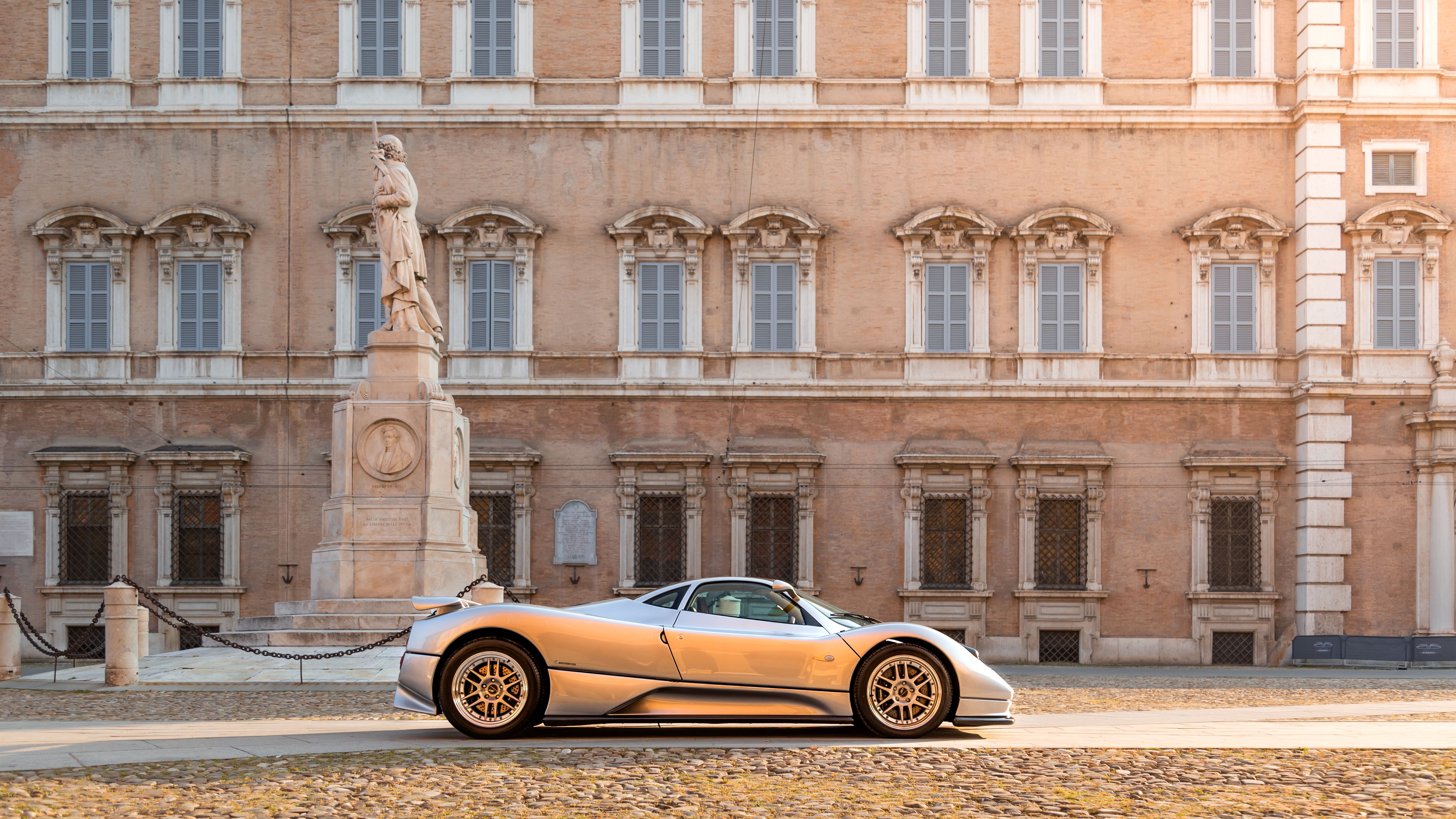 Silver Pagani Zonda C12 side profile in front of a Modena palazzo